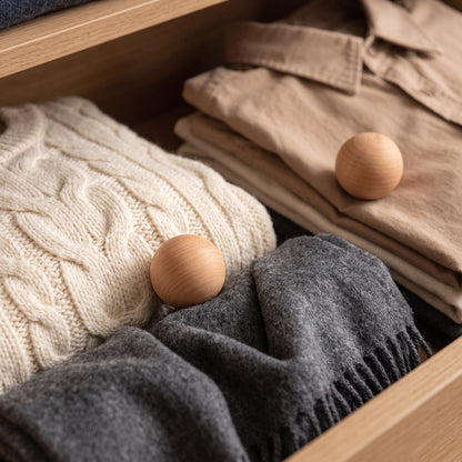 Swedish red cedar moth balls placed among folded clothes in a wardrobe drawer