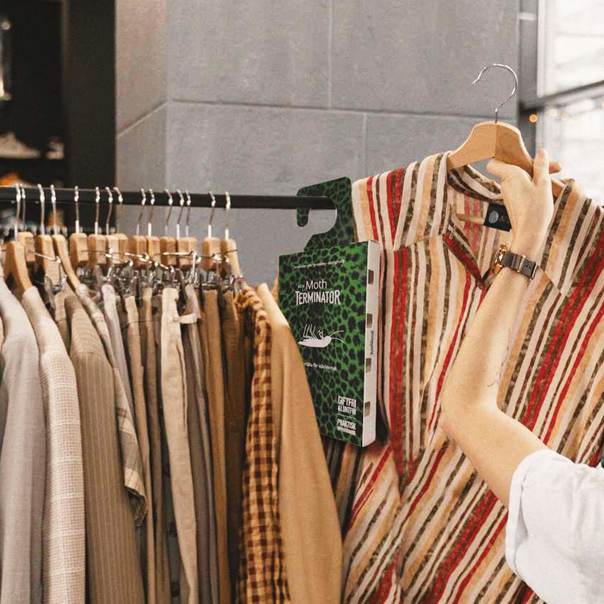 Carpet moth trap hanging inside a wardrobe to help monitor clothes moth activity